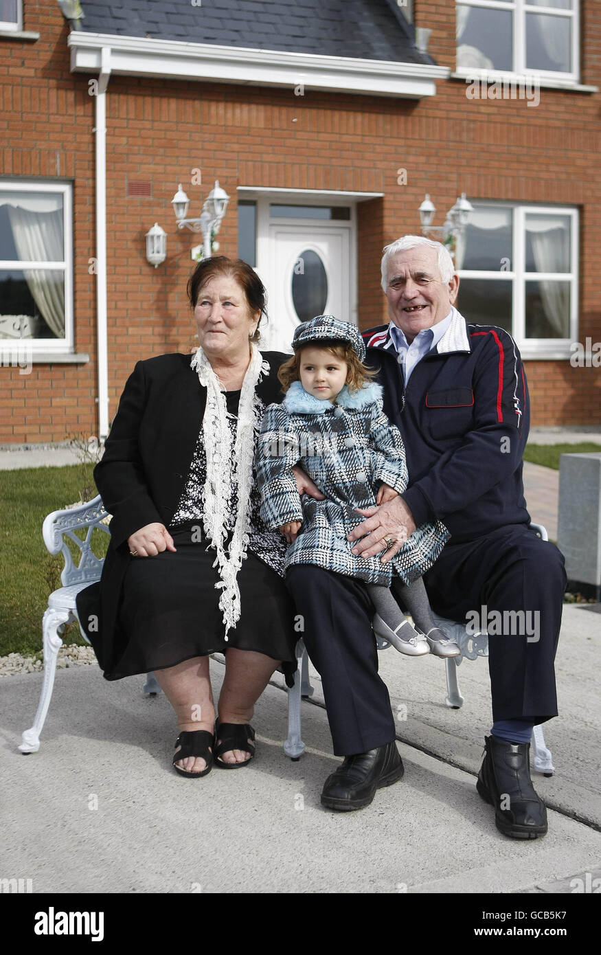 Settled travellers John and Brigid McDonagh and their great grand daughter Reanna at the official hand over of their new home at Newcastle Co Dublin. Stock Photo