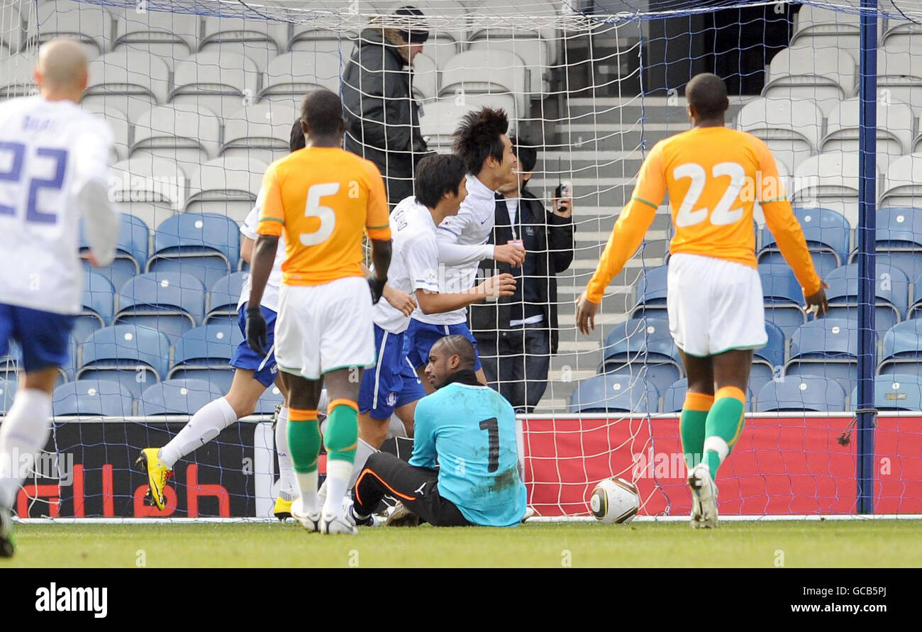 Korea's Lee Dong-Gook (centre) celebrates with teammates after scoring the first goal of the game during the International Friendly at Loftus Road, London. Stock Photo