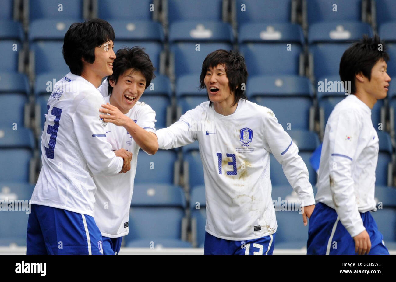 South Korea's Kwak Tae-Hwi (left) celebrates scoring their second goal of the game with teammates during the International Friendly at Loftus Road, London. Stock Photo