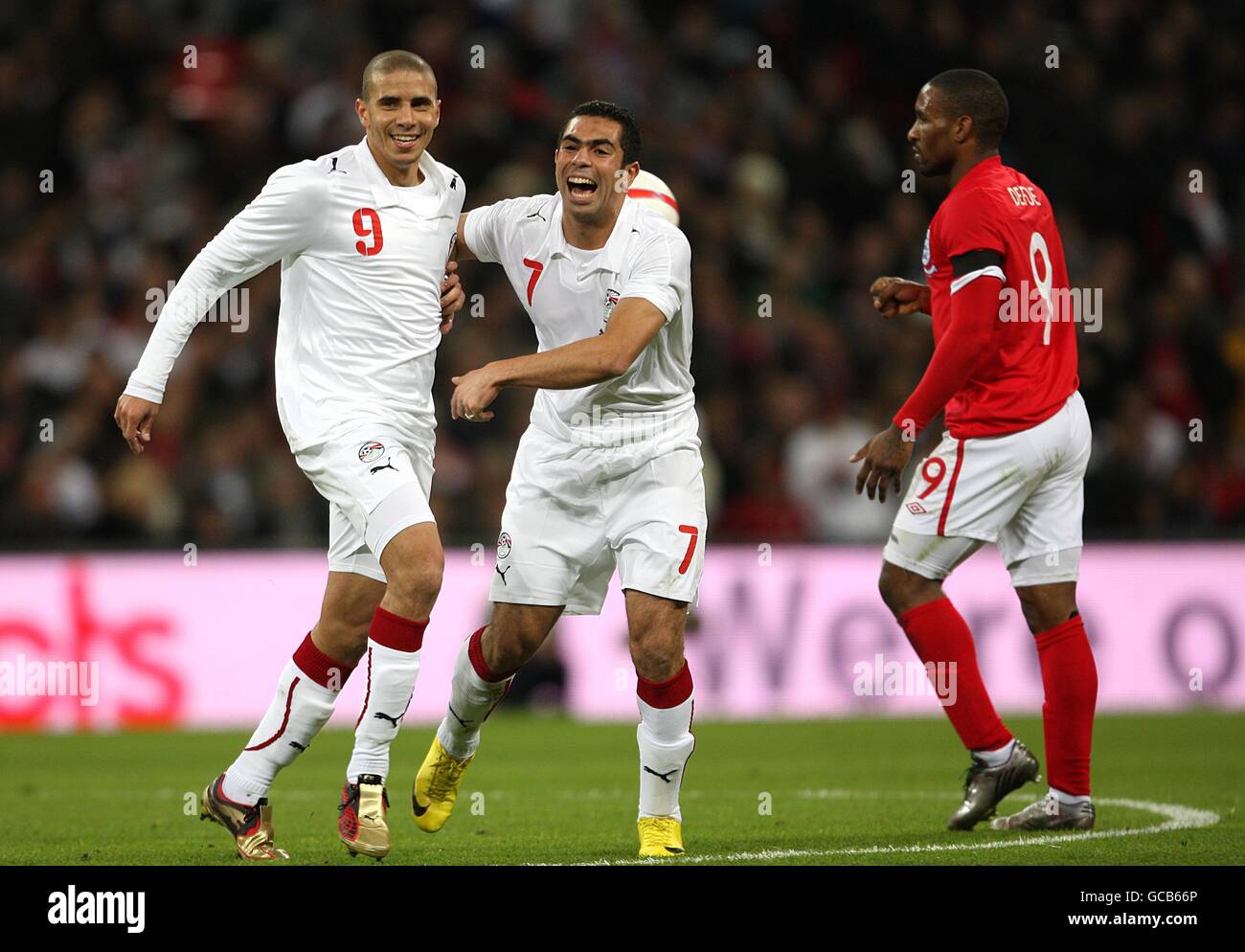 Egypt's Mohamed Zidan (left) celebrates with team mate Ahmed Fathi after scoring his side's first goal of the game, as England's Jermain Defoe looks on Stock Photo