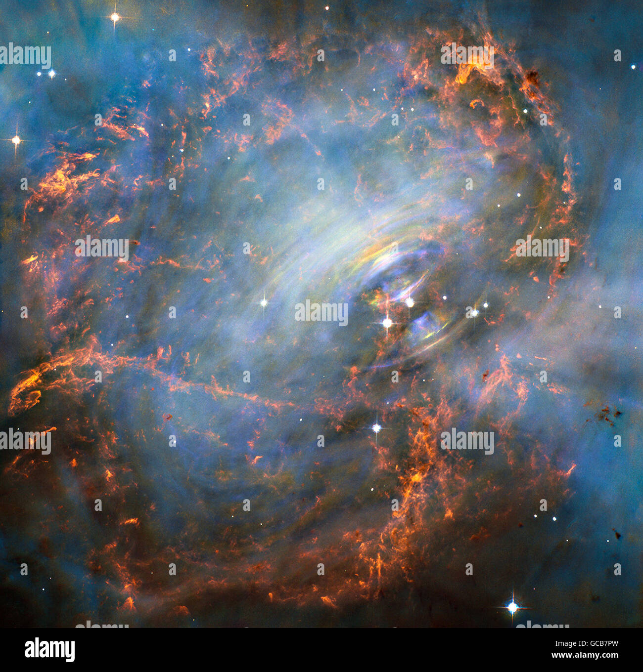 NASA's Hubble Space Telescope view deep into the core of the Crab Nebula, this close-up image reveals the beating heart of one of the most historic and intensively studied remnants of a supernova, an exploding star. The inner region sends out clock-like pulses of radiation and tsunamis of charged particles embedded in magnetic fields. The neutron star at the very center of the Crab Nebula has about the same mass as the sun but compressed into an incredibly dense sphere that is only a few miles across. Spinning 30 times a second, the neutron star shoots out detectable beams of energy that make Stock Photo