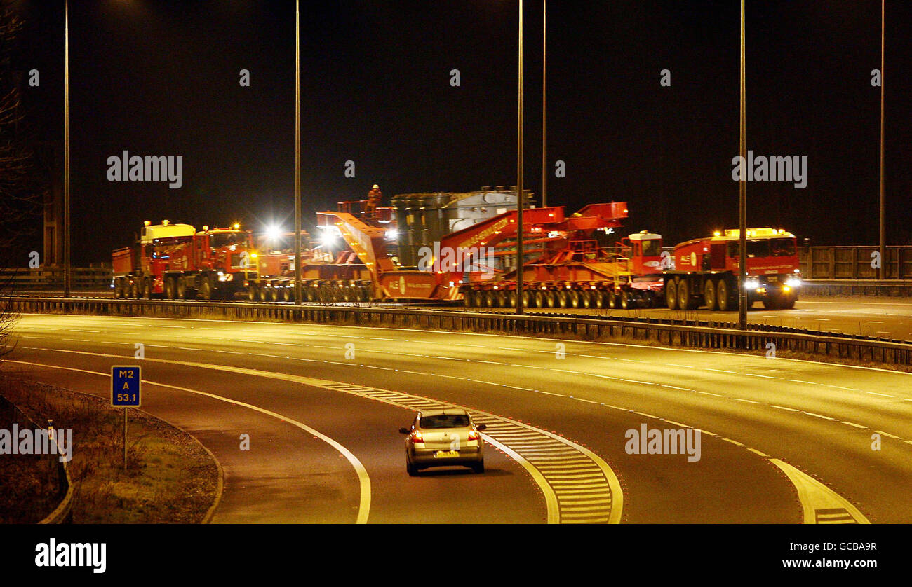 A 428 ton generator is carried on a lorry measuring 104.24 metres in length along the M2 near Chatham in Kent, during its journey from Chatham Docks to the National Grid substation in Kemsley. Stock Photo