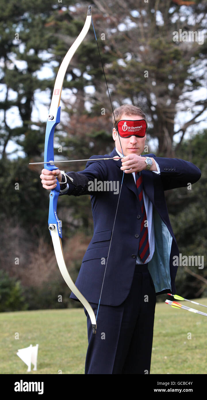 Prince William takes part in an archery lesson wearing a blindfold to