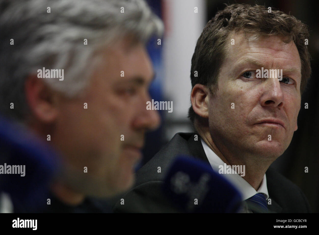 Chelsea head of communications and public affairs Steve Atkins (right) looks on as manager Carlo Ancelotti speaks to the media during the press conference at the San Siro, Milan, Italy. Stock Photo