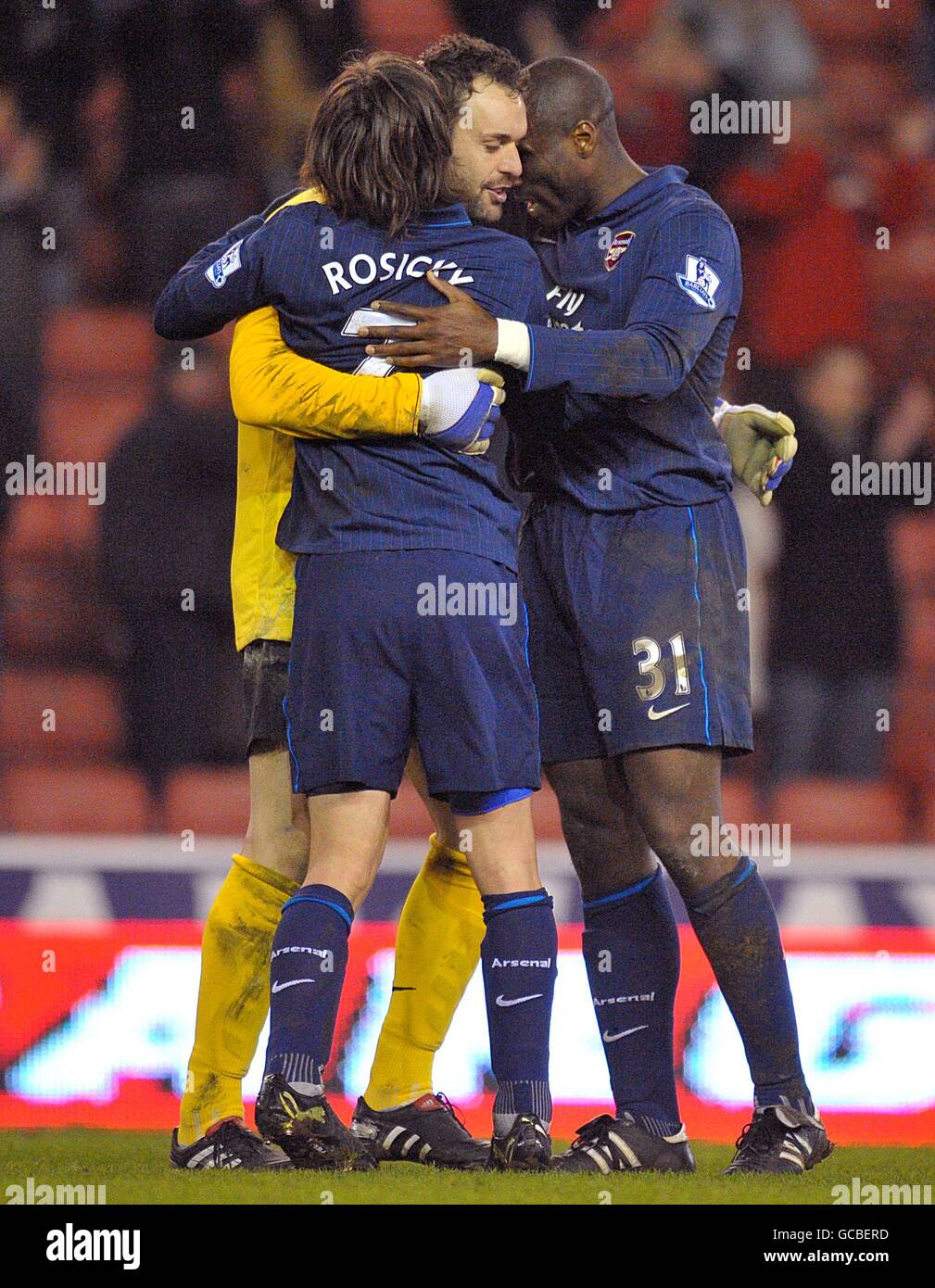 (l-R) Arsenal's Tomas Rosicky, Manuel Almunia and Sol Campbell comfort each other after the final whistle. Stock Photo