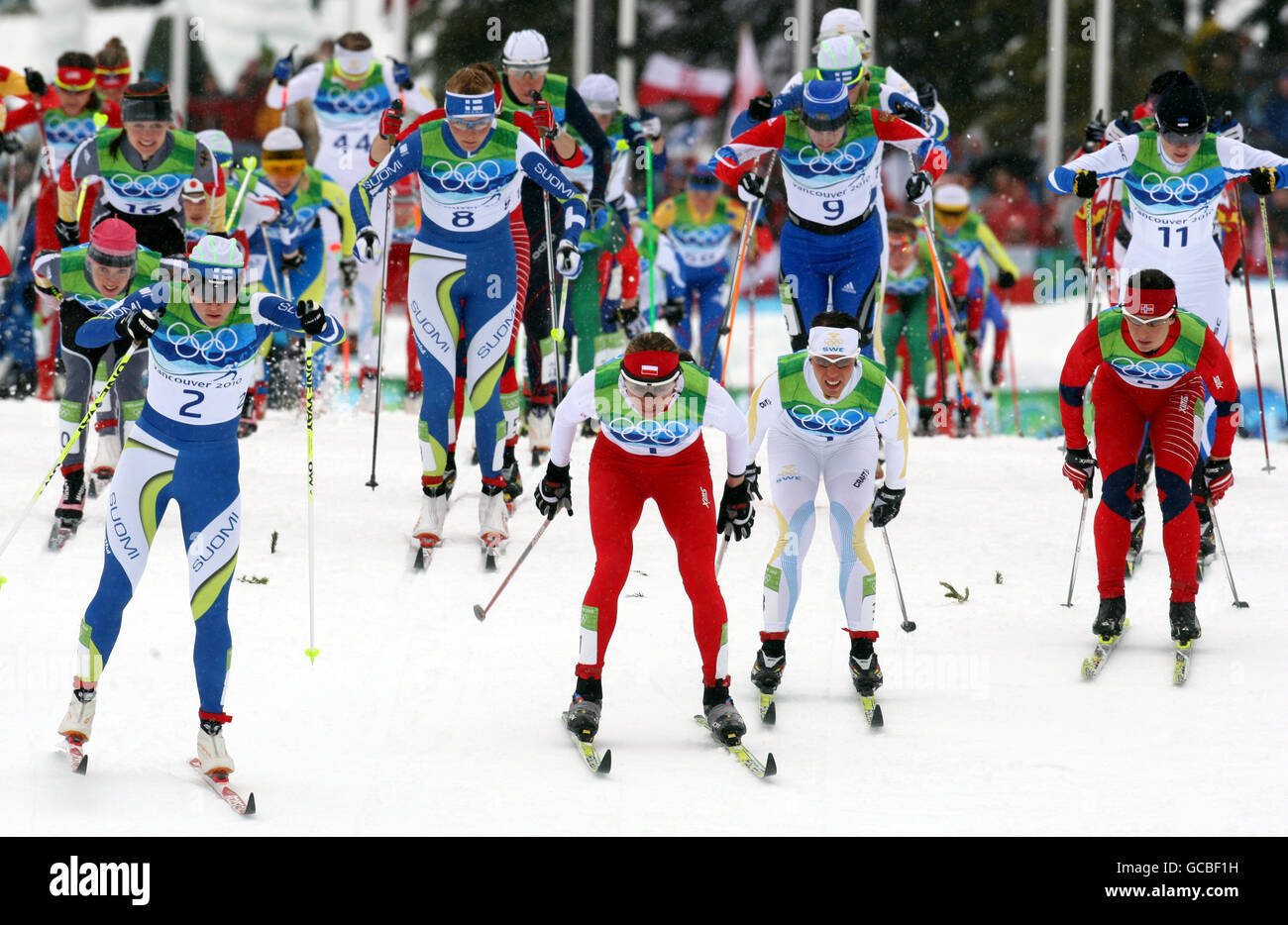 Eventual winner Poland's Justyna Kowalczyk (centre) along with fellow competitors take part in the Cross Country Skiing Womens 30km Mass Start Classic at the Whistler Olympic Park, Whistler, Canada. Stock Photo