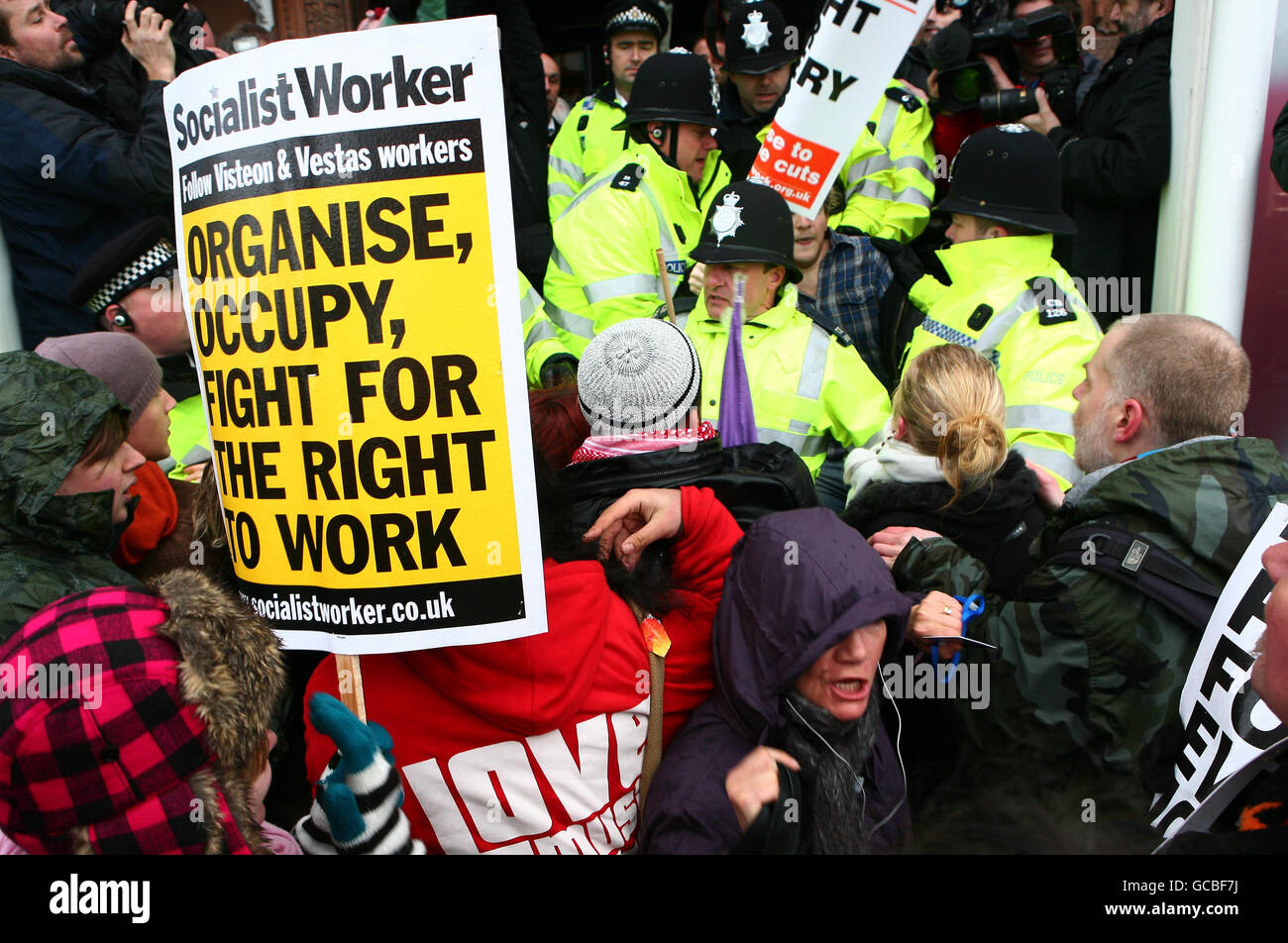 Demonstrators protest against Conservative Party politics at the front door to the Conservative Party Spring Forum in Brighton, East Sussex. Stock Photo