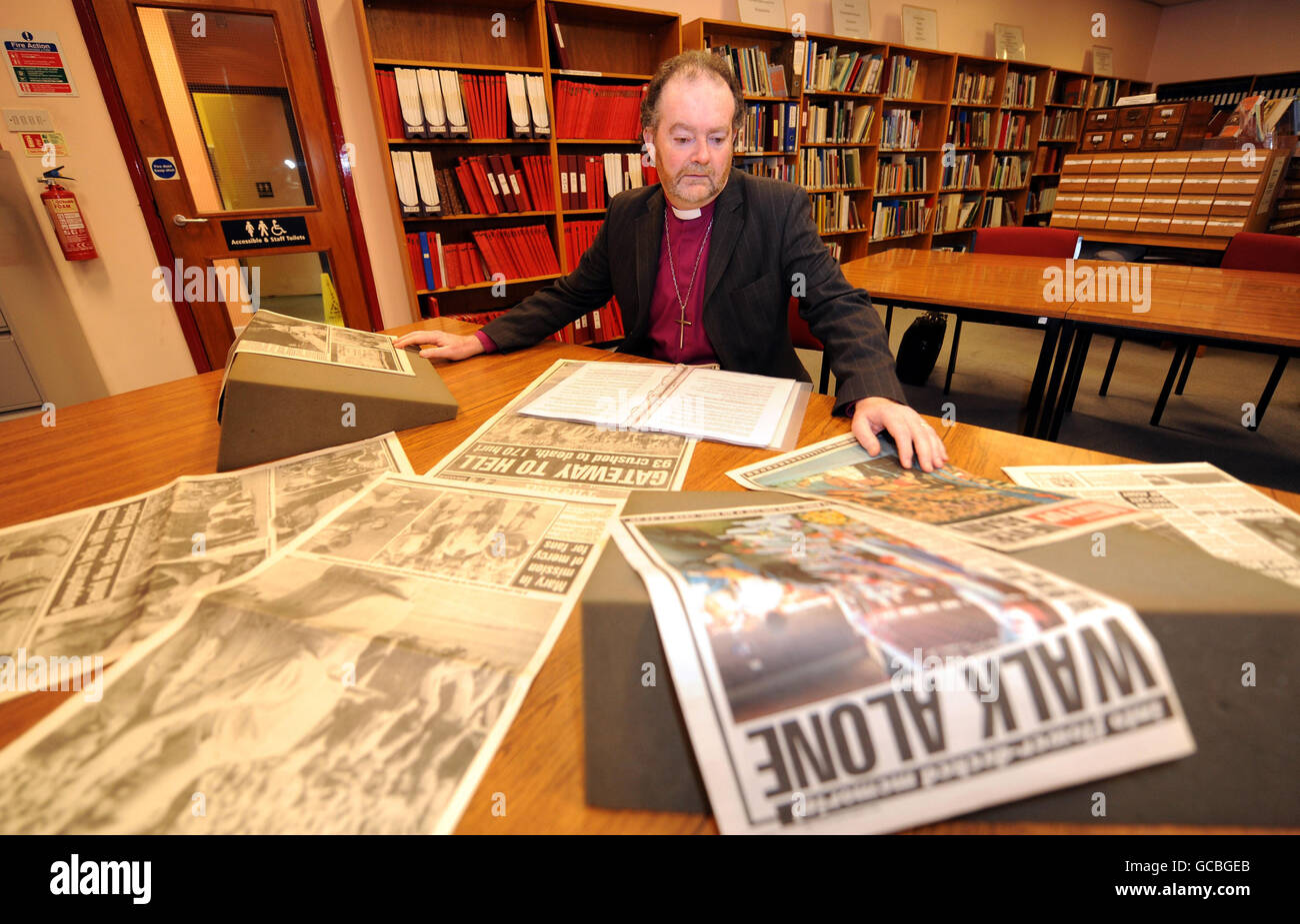 The Bishop of Liverpool, the Rt Rev James Jones, looks at some of the material in the Hillsborough Archive in Sheffield. Stock Photo