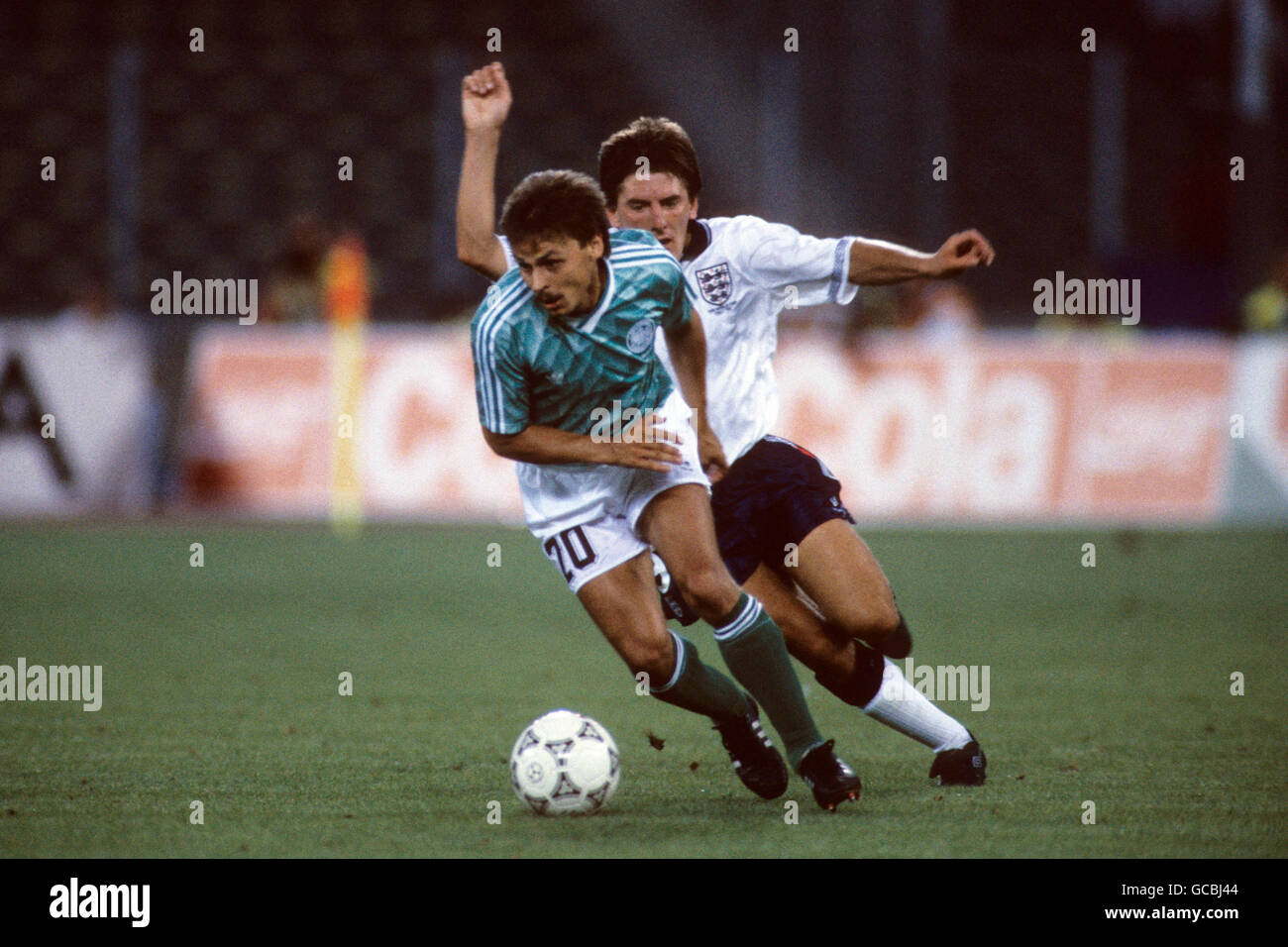 Soccer - World Cup Italia 1990 - Semi Final - West Germany v England - Stadio Delle Alpi. West Germany's Olaf Thon gets away from England's Peter Beardsley (r) Stock Photo