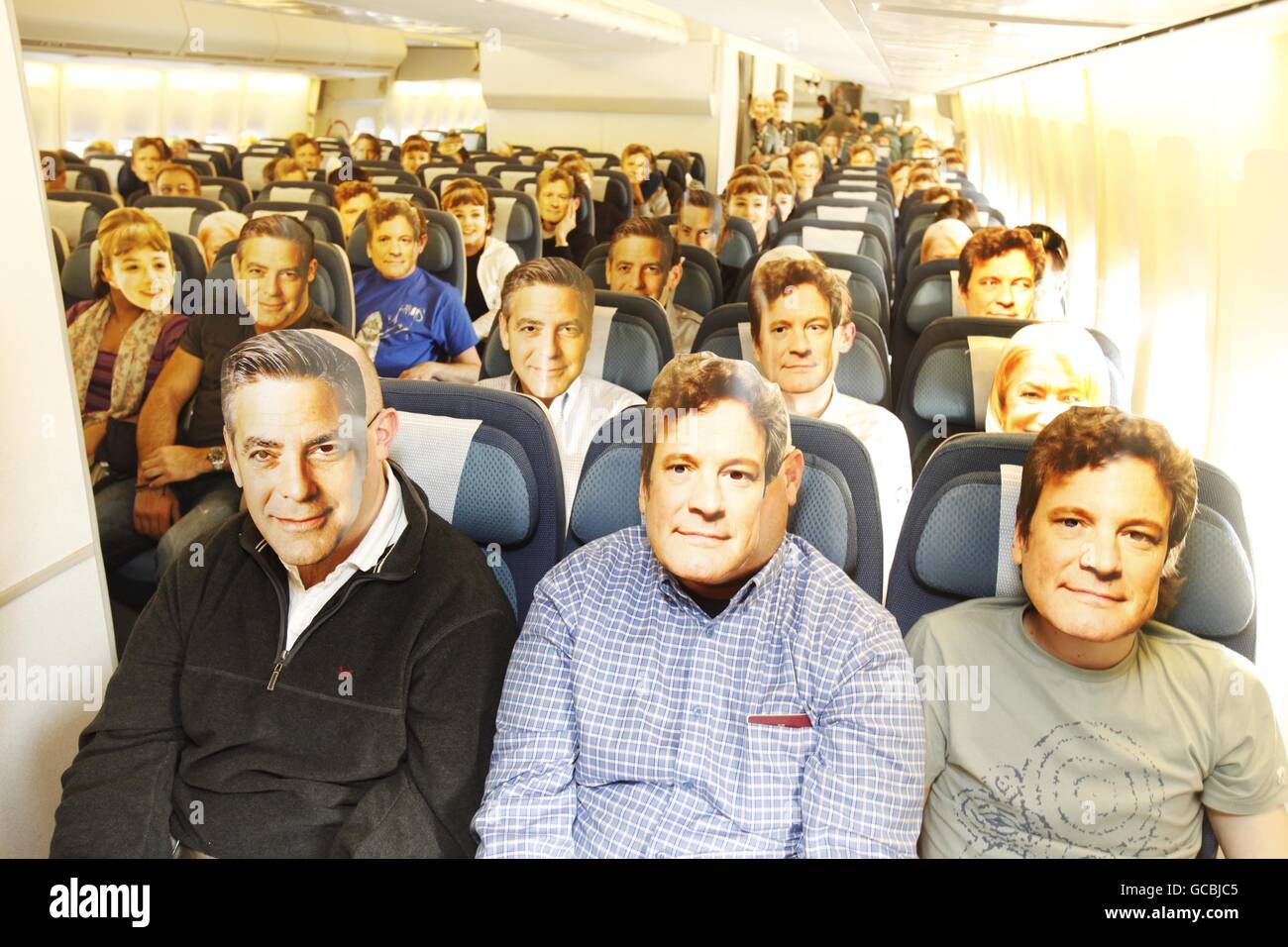 Air New Zealand passengers on NZ1 from London Heathrow to Los Angeles wear masks of Oscar nominees Colin Firth, George Clooney, Helen Mirren and Carey Mulligan. Stock Photo