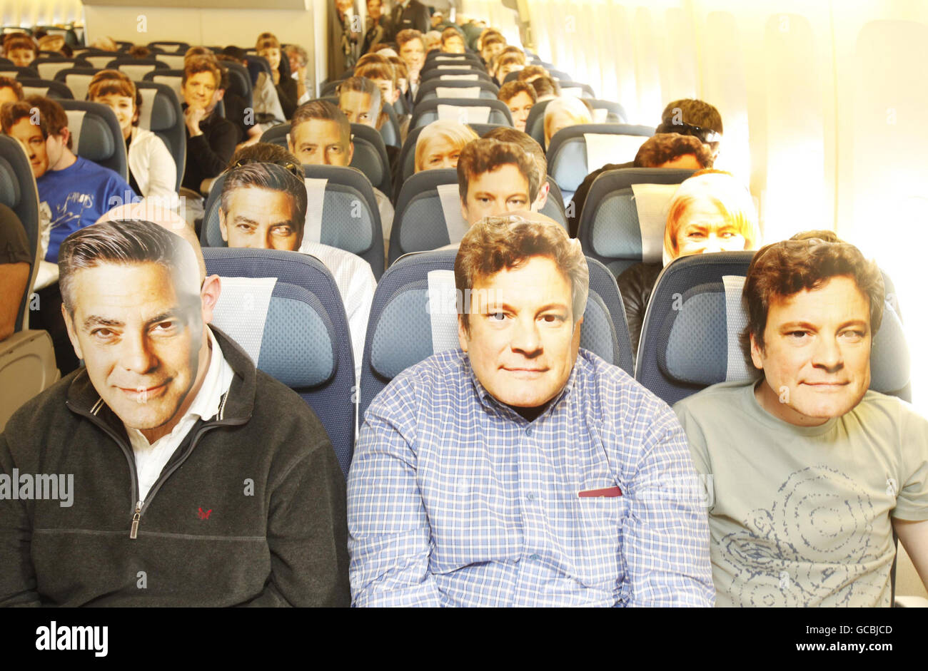 Air New Zealand passengers on NZ1 from London Heathrow to Los Angeles wear masks of Oscar nominees Colin Firth, George Clooney, Helen Mirren and Carey Mulligan. Stock Photo