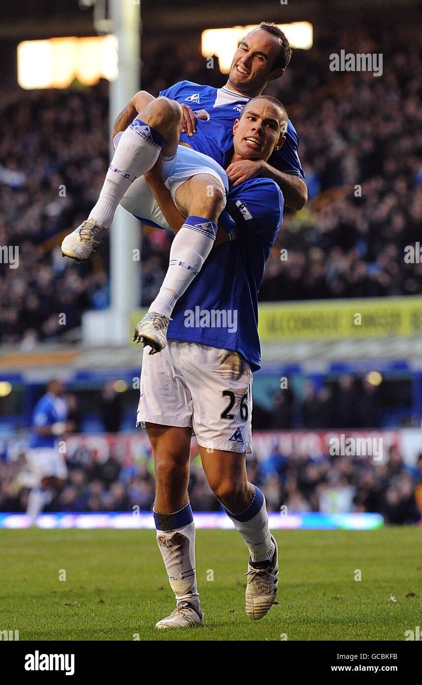 Everton's Landon Donovan is lifted off the ground by Jack Rodwell