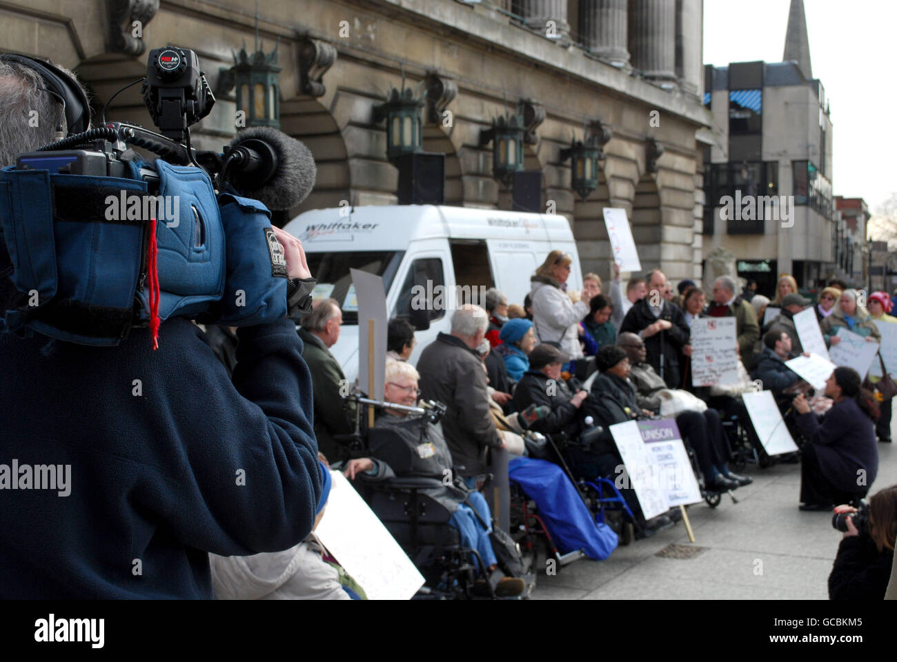 ITN News films protesters to Government spending Cuts on local services outside the Nottingham City Council House, Nottingham. Stock Photo