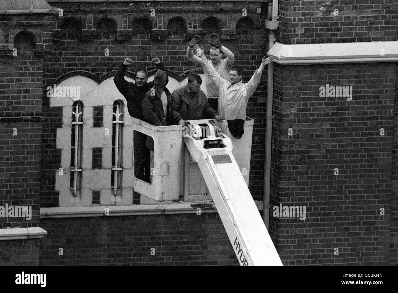 Ringleader Paul Taylor (second right) comes down with the remaining rioters as the siege at Strangeways ends. Stock Photo