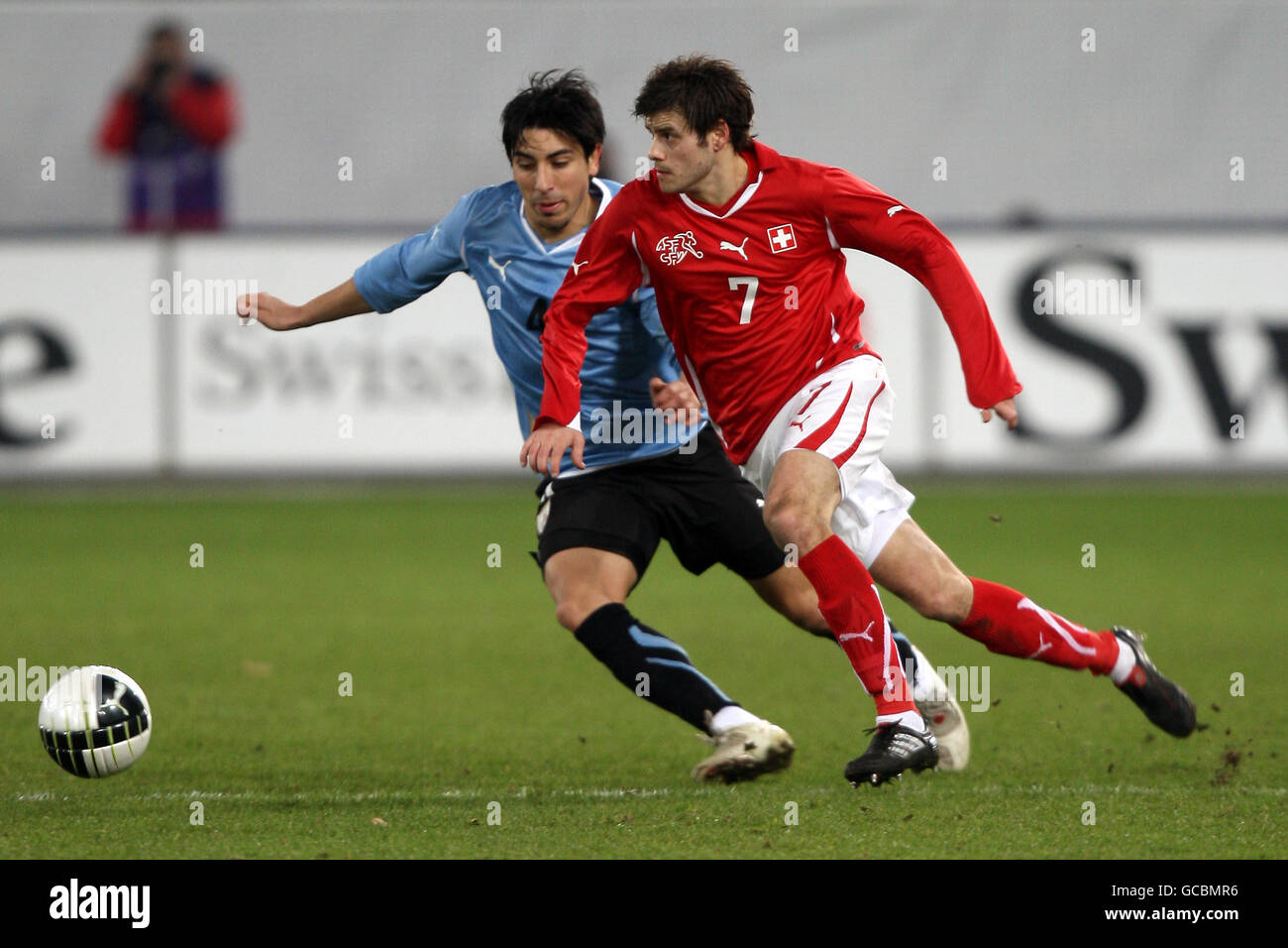 Soccer - International Friendly - Switzerland v Uruguay - AFG Arena. Switzerland's Tranquillo Barnetta (r) takes on Uruguay's Jorge Fucile Stock Photo