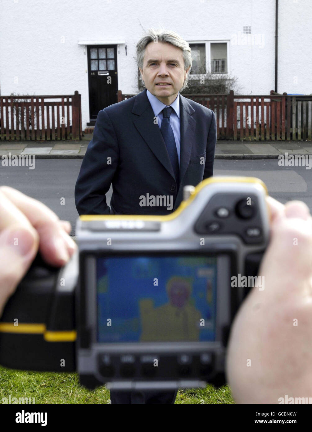 Science Minister Lord Drayson stands in front of a thermal imaging camera during his visit to one of the projects in Eltham, south east London for the launch of the Technology Strategy Board's 'Retrofit for the Future', a programme, the first of its kind in the UK, which will see social housing units across the country retrofitted with new, innovative technologies. Stock Photo