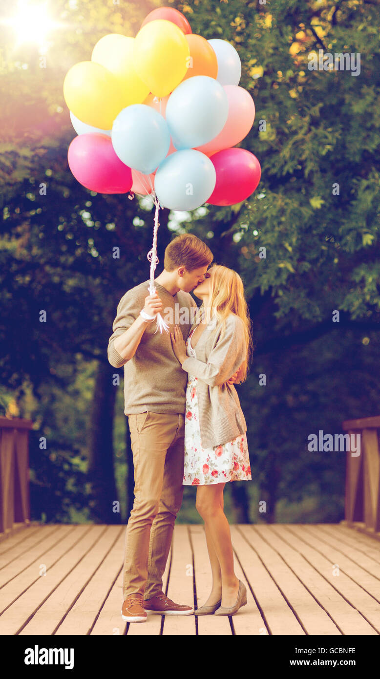 couple with colorful balloons kissing in the park Stock Photo - Alamy