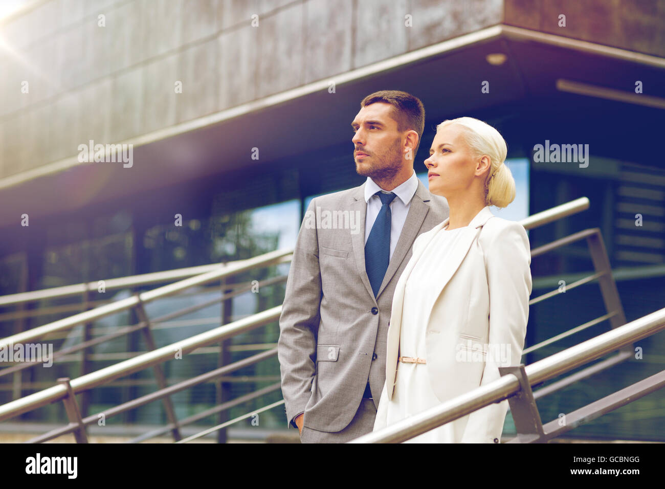 serious businessmen standing over office building Stock Photo - Alamy