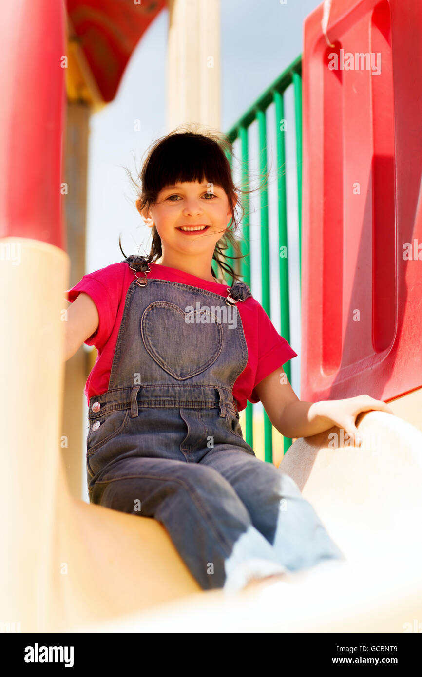 happy little girl on slide at children playground Stock Photo - Alamy