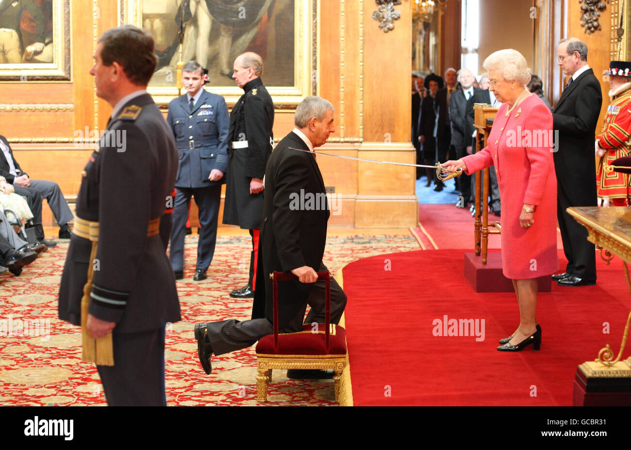 British and Irish Lions coach Sir Ian McGeechan is knighted by Queen Elizabeth II at Windsor Castle. Stock Photo