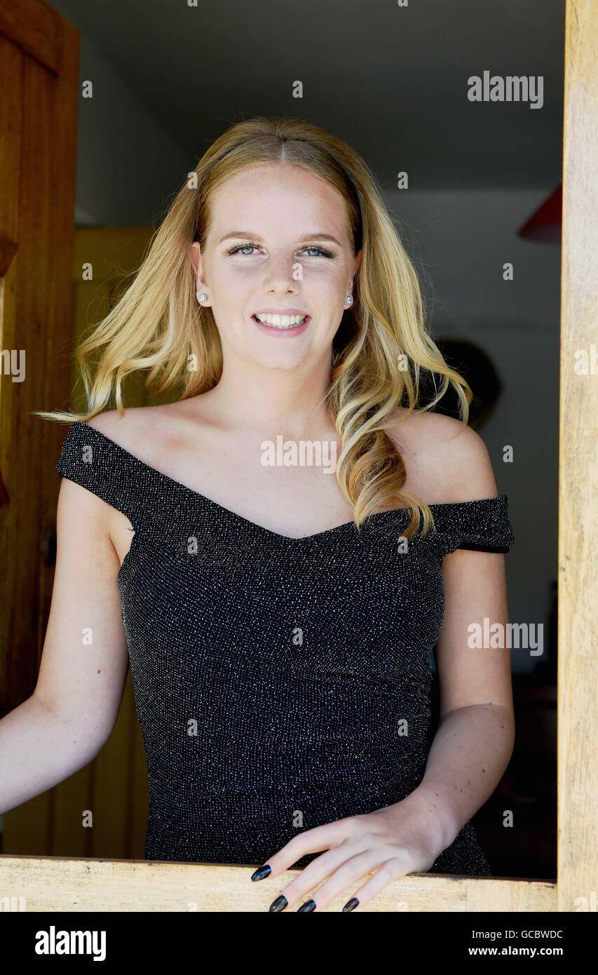 Teenage girl sixteen years old wearing glamorous ball gown for her school prom night UK Stock Photo