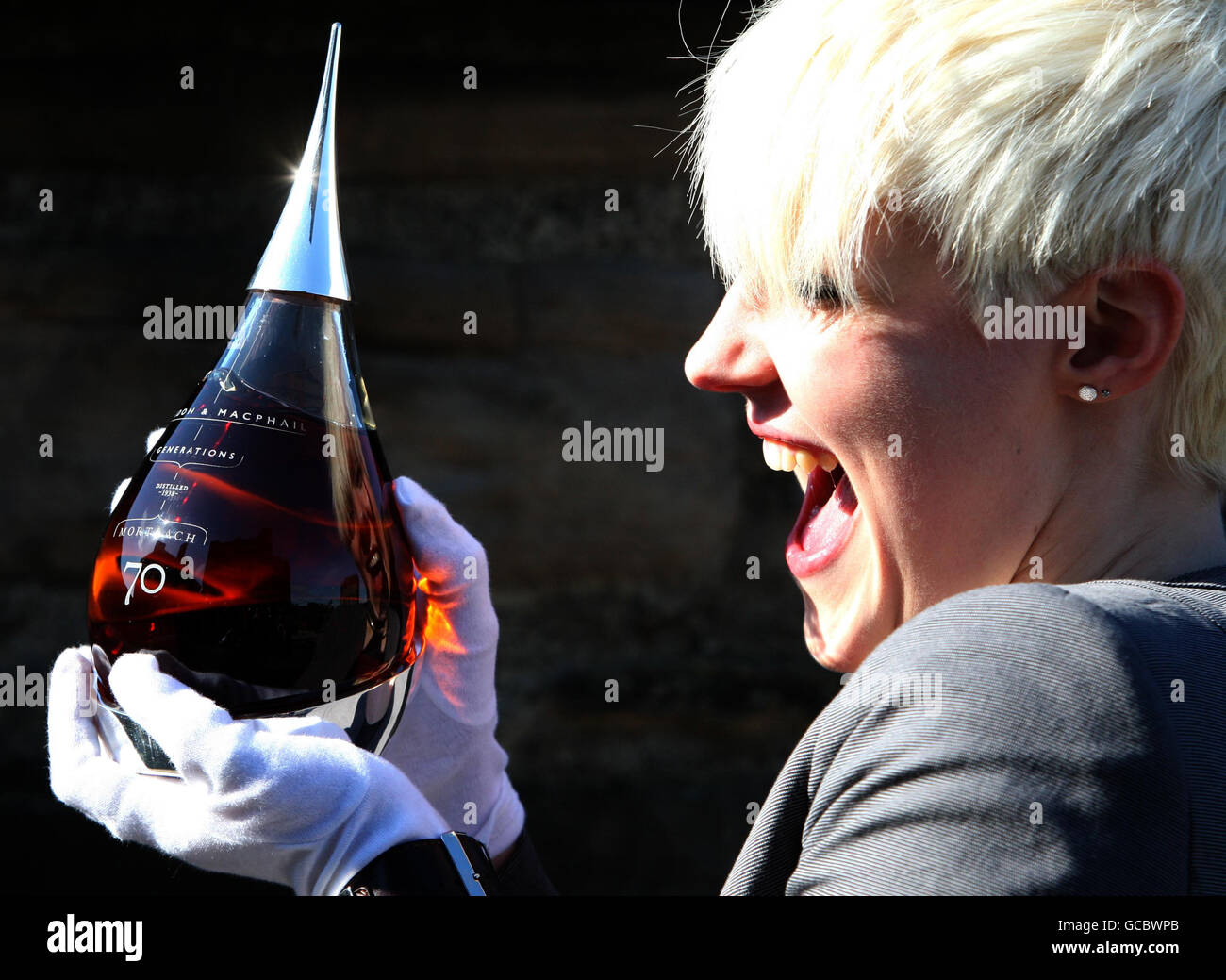 Claire Urquhart from Gordon and MacPhail holds a bottle of the world's oldest bottled single malt whisky, Mortlach 70 years old Speyside Single Malt Whisky, which has been revealed today at Edinburgh Castle by the whisky specialists. Stock Photo