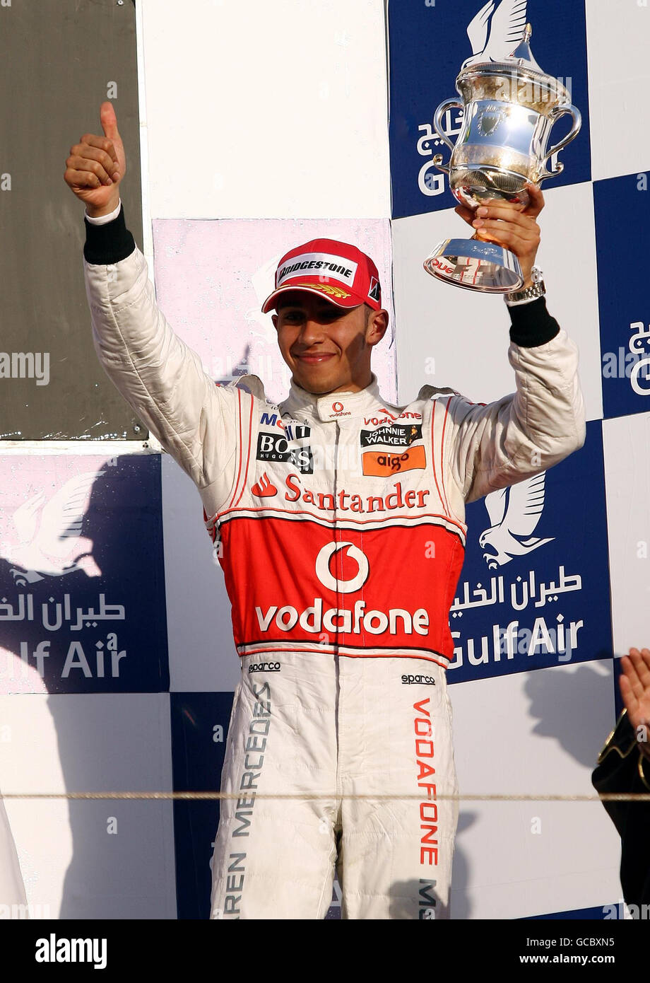 McLaren's Lewis Hamilton celebrates his third place during the Gulf Air Bahrain Grand Prix at the Bahrain International Circuit in Sakhir, Bahrain. Stock Photo