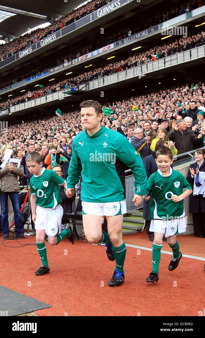 Ireland's Brian O'Driscoll accompanied by mascots Rossa Ryan (left) and Evan Moran takes the field for his 100th cap before the RBS Six Nations match at Croke Park, Dublin. Stock Photo