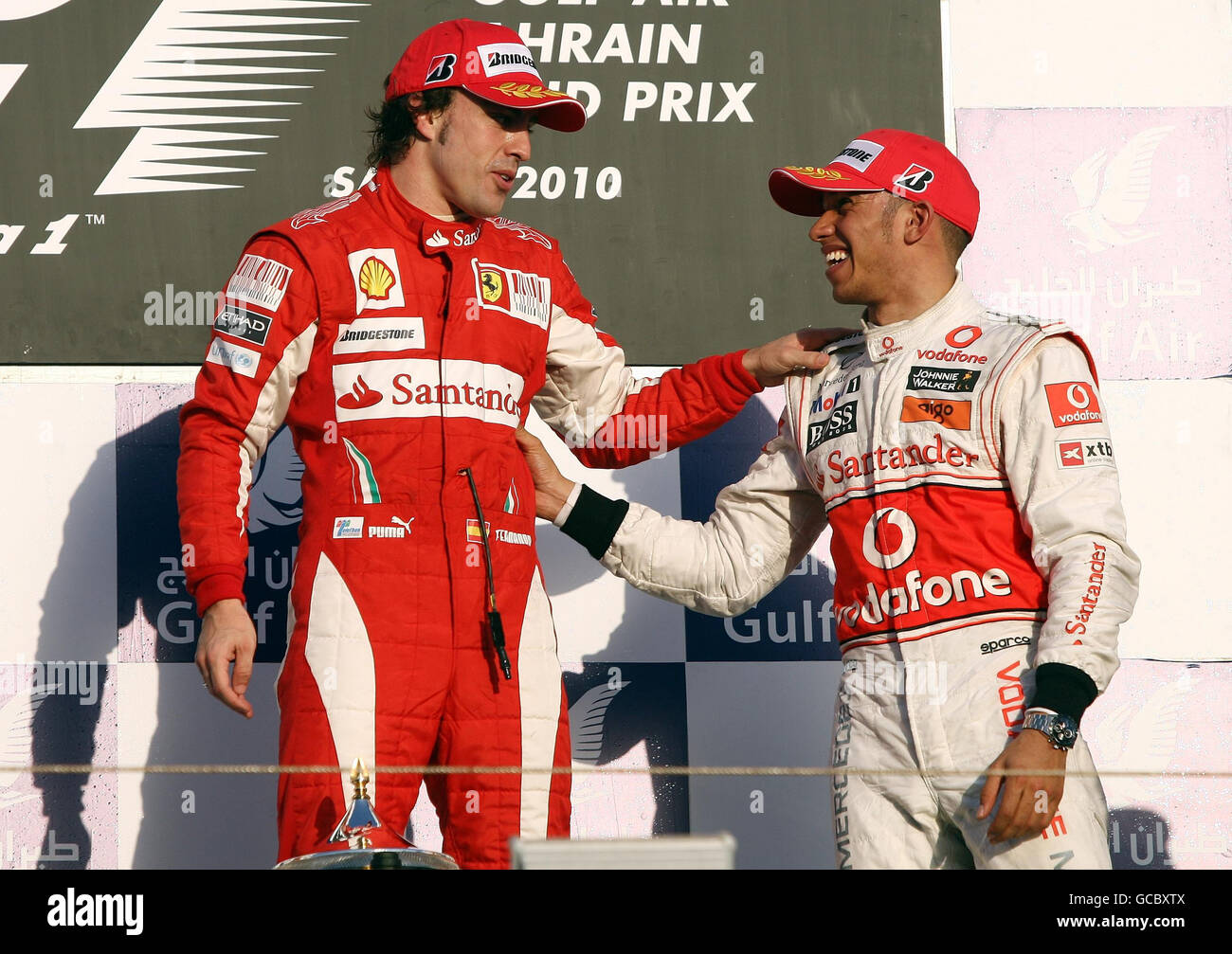 McLaren's Lewis Hamilton (right) congratulates Ferrari's Fernando Alonso on his victory during the Gulf Air Bahrain Grand Prix at the Bahrain International Circuit in Sakhir, Bahrain. Stock Photo