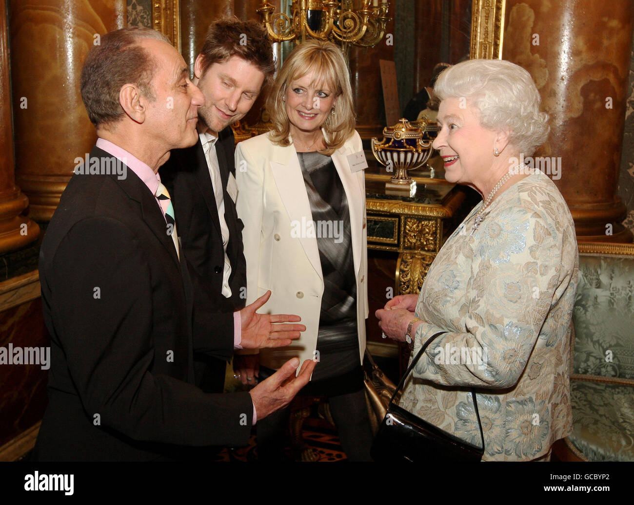 Queen Elizabeth II speaks to (left to right) David Sassoon, Christopher Bailey from Burberry, and model Twiggy at a reception for the British Clothing Industry, including an exhibition of contemporary clothing curated by the Victoria and Albert Museum, at Buckingham Palace, London. Stock Photo