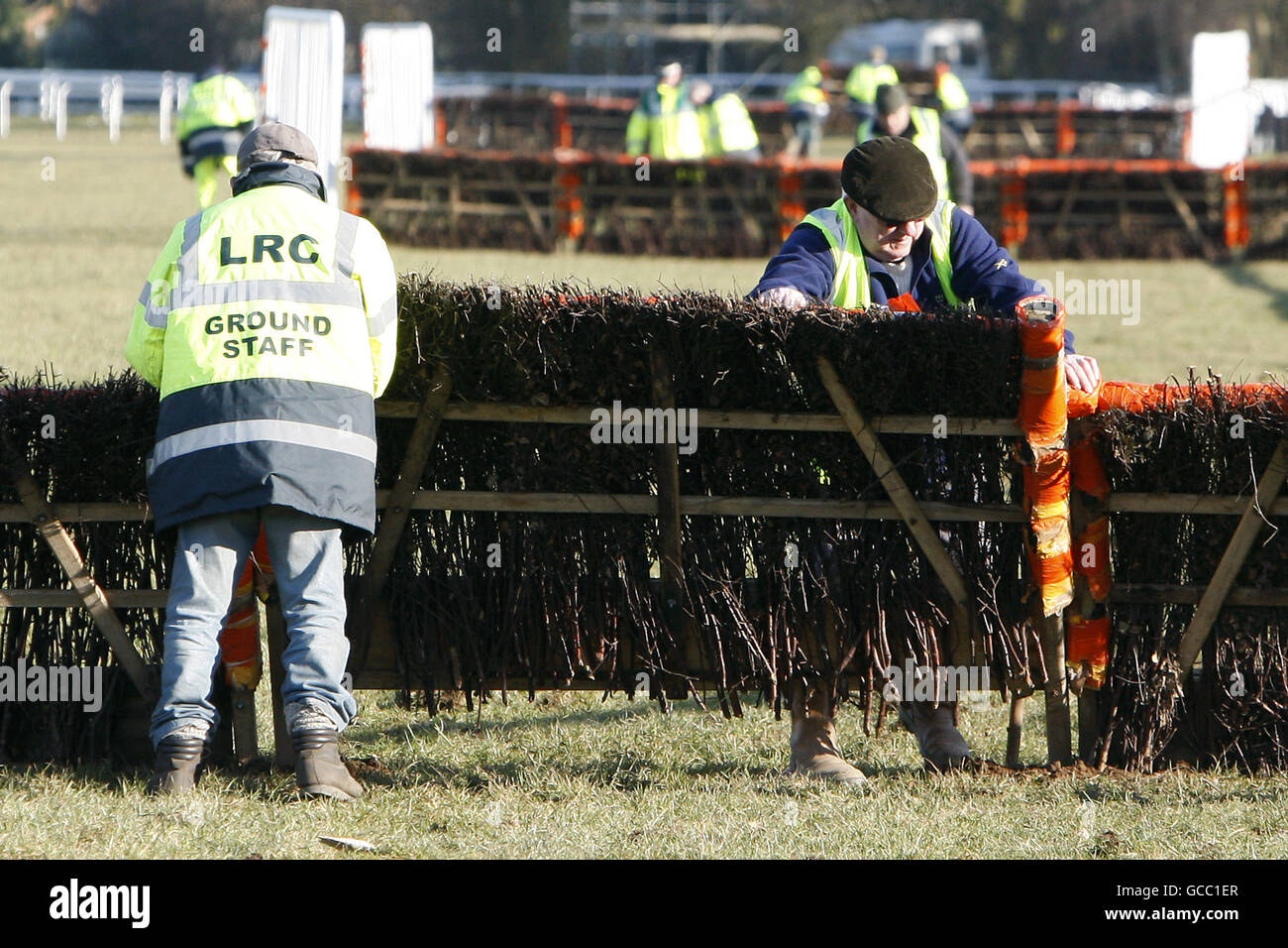 Horse Racing - Ludlow Racecourse. Ground staff repair the fence after the race Stock Photo