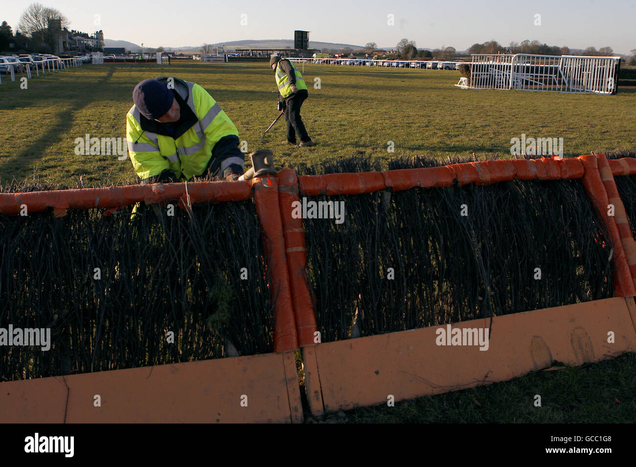 Horse Racing, Ludlow Racecourse. Ground staff repair the fence after the race Stock Photo