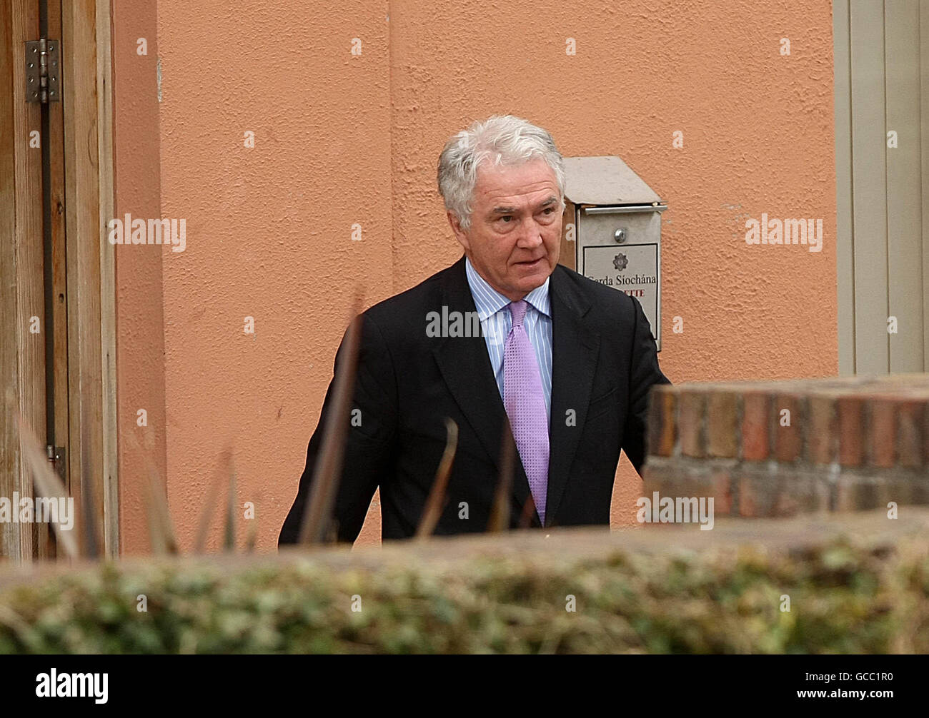 Sean Fitzpatrick former chief of Anglo Irish Bank leaves Bray Garda