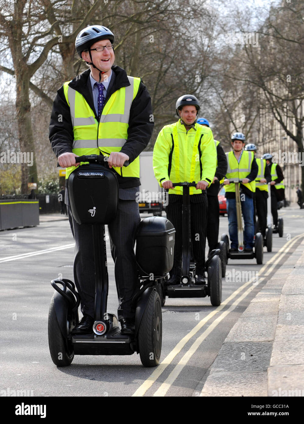 Liberal Democrat MP Lembit Opik and others ride through Westminster, London, on Segways as supporters of the two-wheeled, self-balancing mode of transport petitioned the Government to lift the roads ban on the electric vehicle. Stock Photo