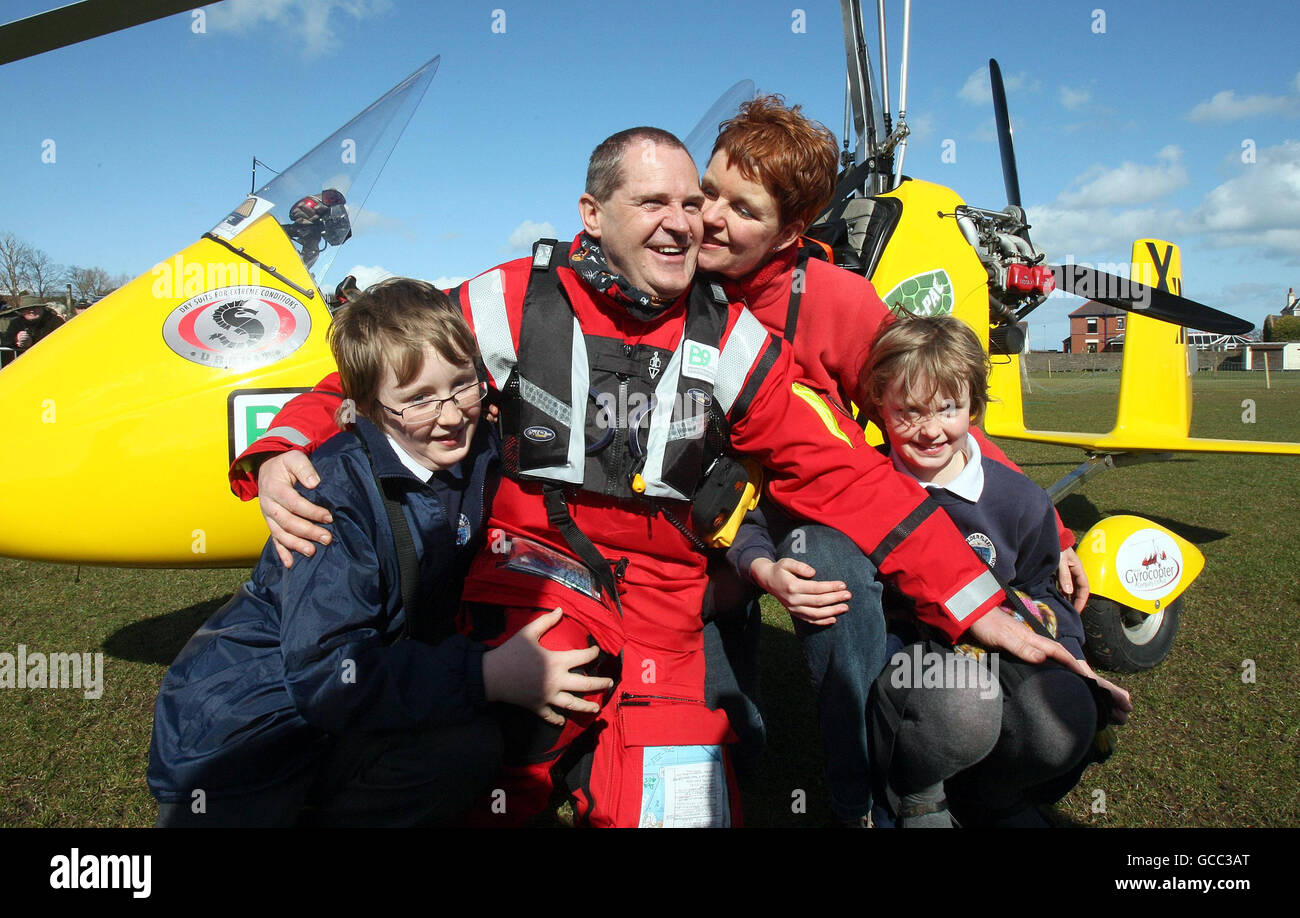 Norman Surplus says goodbye to his wife Celia and children Felix, 11, and  Petra, 8, as he prepares to take off from Larne in Co Antrim, in an epic  bid to become