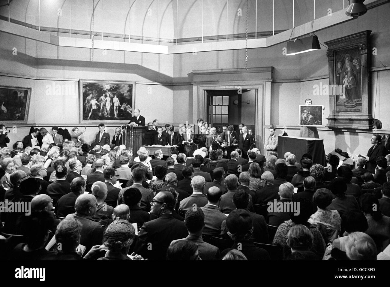 The scene during the auction of Sir Peter Paul Rubens paintings at Christie's in London. Bids are being made for a modello painting, 'Samson and Delilah', which was sold for 24,000 guineas to the Hallsborough gallery in London. On the wall behind auctioneer Ivan Chance is 'The Judgment of Paris' a Rubens painting, owned by Edna Savage, bought in 1933 in a job lot of pictures. It failed to meet its reserve price and was bought in at 24,000 guineas. Stock Photo