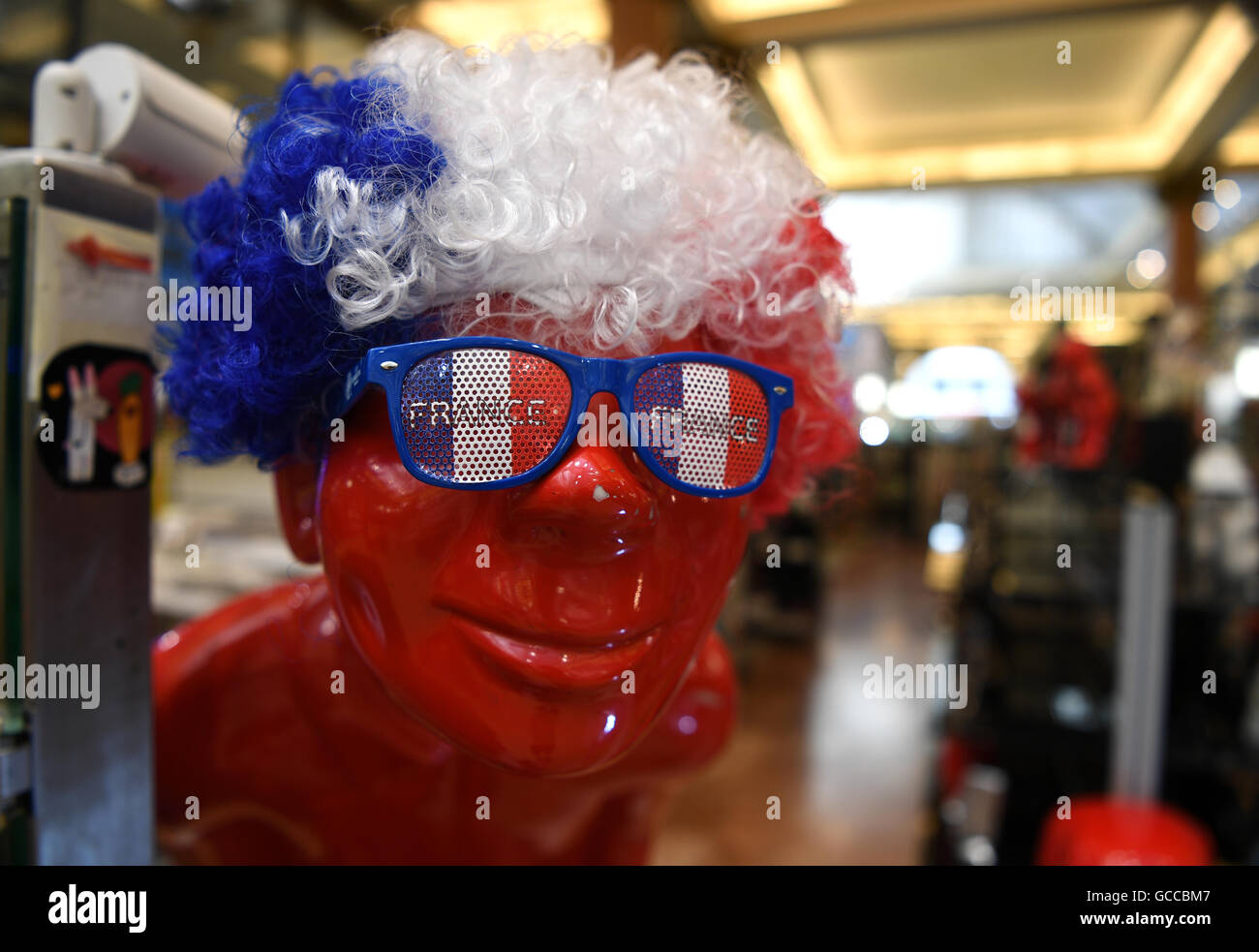 Paris, France. 09th July, 2016. A dummy bewigged in French national colors stands in souvenir shop at the Avenue des Champs-Elysees in Paris, France, 09 July 2016. Portugal face France in the UEFA EURO 2016 soccer Final match on 10 July 2016. Photo: Federico Gambarini/dpa/Alamy Live News Stock Photo