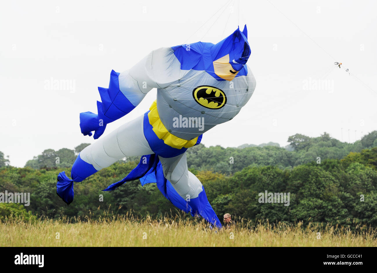 Brighton, UK. 9th July, 2016. Guy Reynolds launches his giant Batman kite in blustery but perfect weather conditions for flying at the annual Brighton Kite Festival held in Stanmer Park on the outskirts of the city over the weekend Credit:  Simon Dack/Alamy Live News Stock Photo