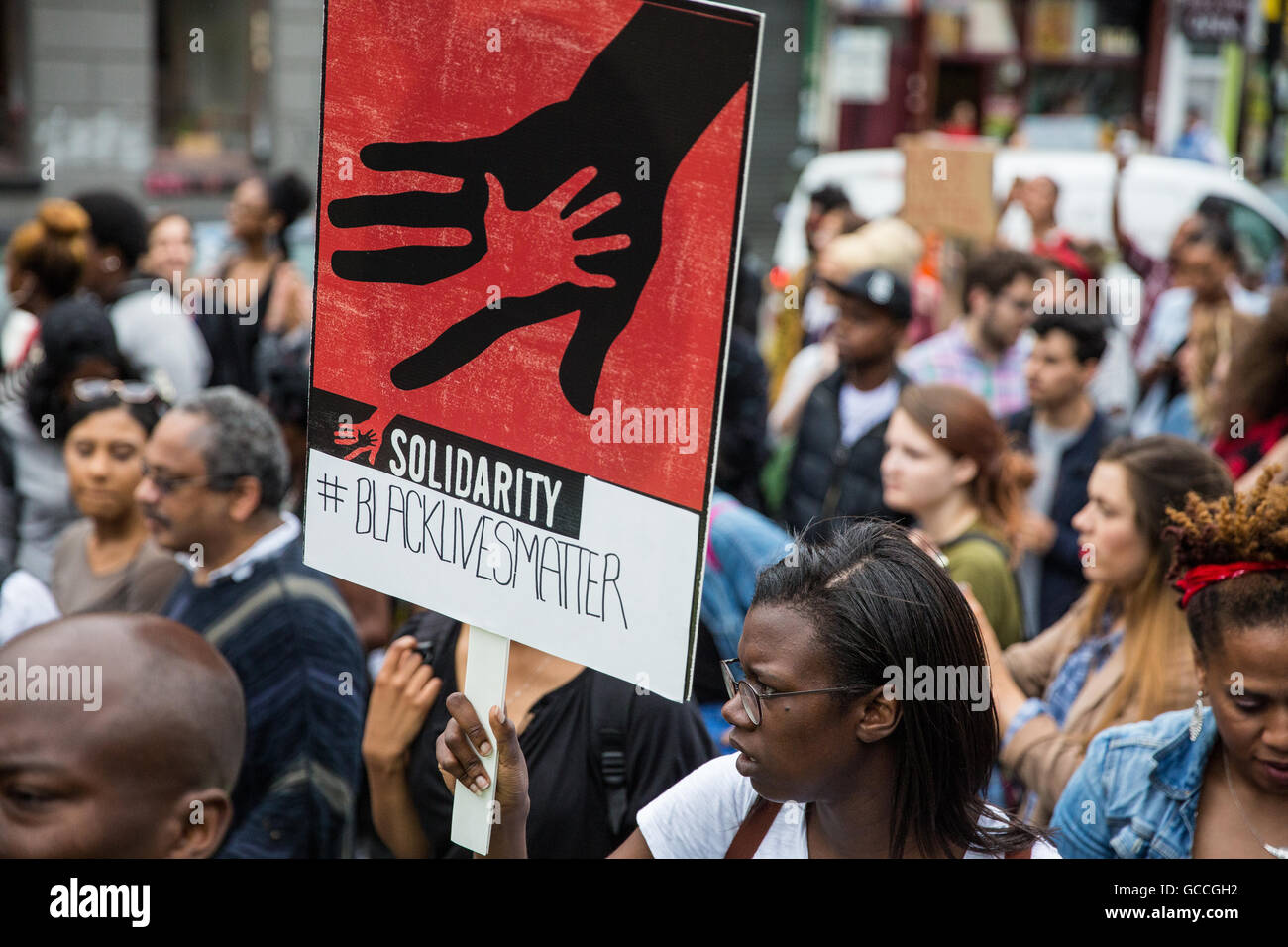 London, UK. 9th July, 2016. Campaigners from groups including Black Lives Matter UK march in Brixton in solidarity with Alton Sterling and Philando Castile, who were fatally shot by police in Dallas and Minnesota last week. Those attending the march also remembered many other victims of police violence, both in the US and in the UK. Stock Photo