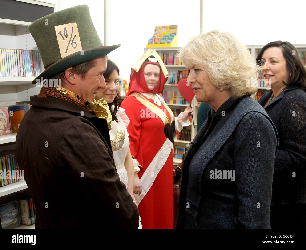 The Duchess of Cornwall meets Katherine Kingsford (Queen of Hearts), Tom Walker (Mad Hatter) and Marieke Van Hoof (Alice) during a visit to a Mad Hatter's Tea Party at Foyles, Westfield in London, to mark World Book Day Stock Photo