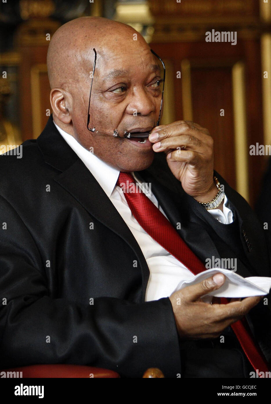 The President of South Africa Jacob Zuma cleans his glasses before ...