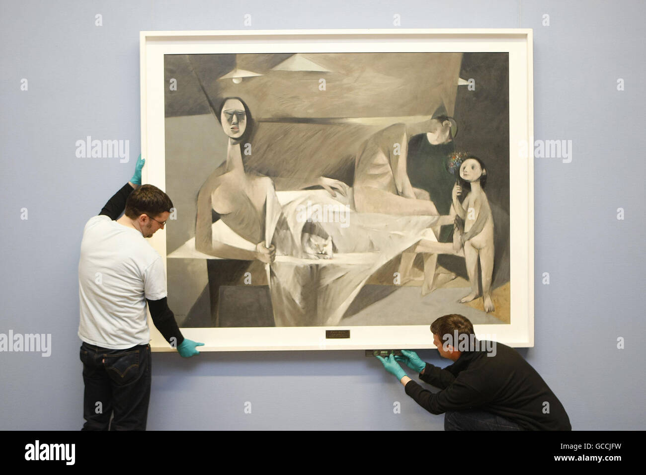 Art handlers from the National Gallery of Ireland in Dublin hang Louis