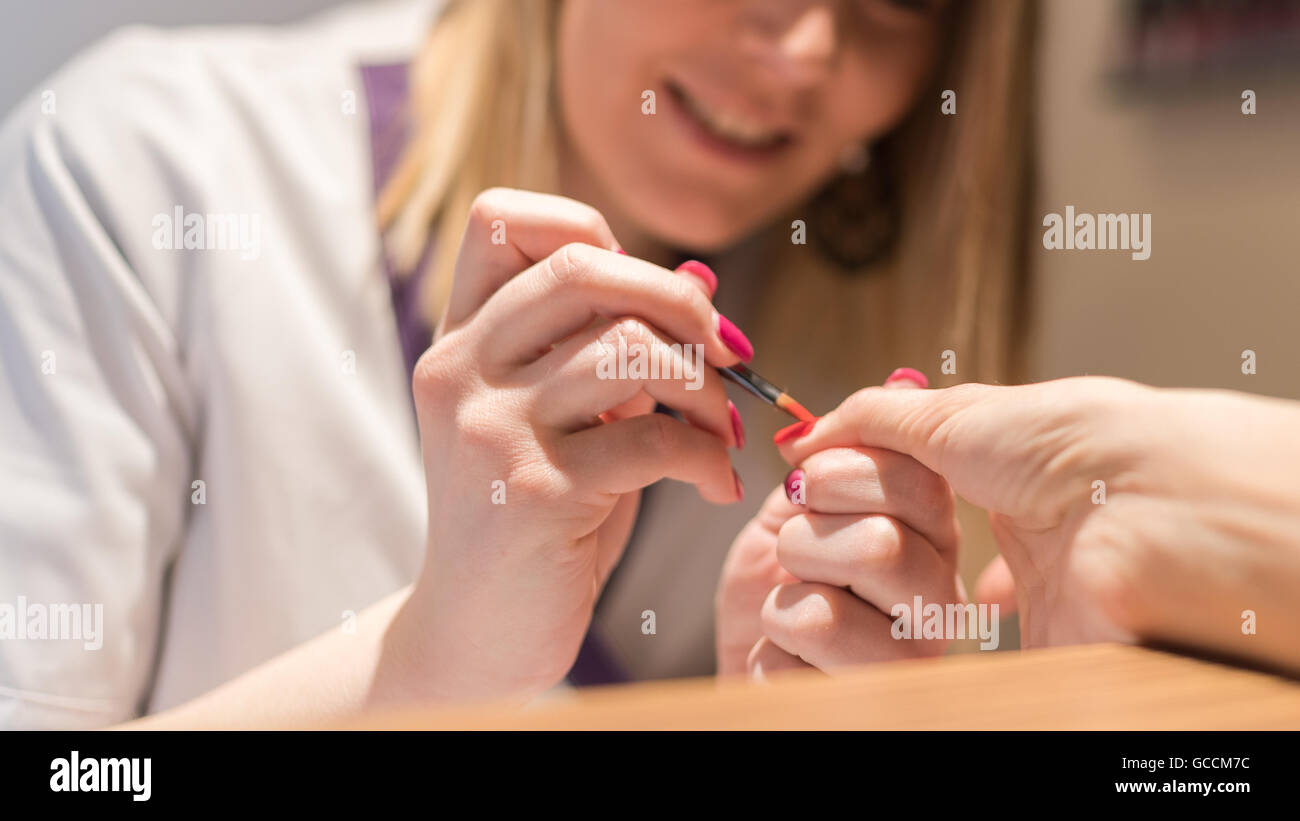 Applying nail polish in a beauty salon. Stock Photo