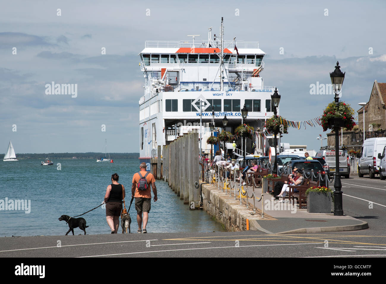 YARMOUTH HARBOUR ISLE OF WIGHT  A roll on roll off ferry berthed on the waterfront and passengers walk their pet dogs Stock Photo