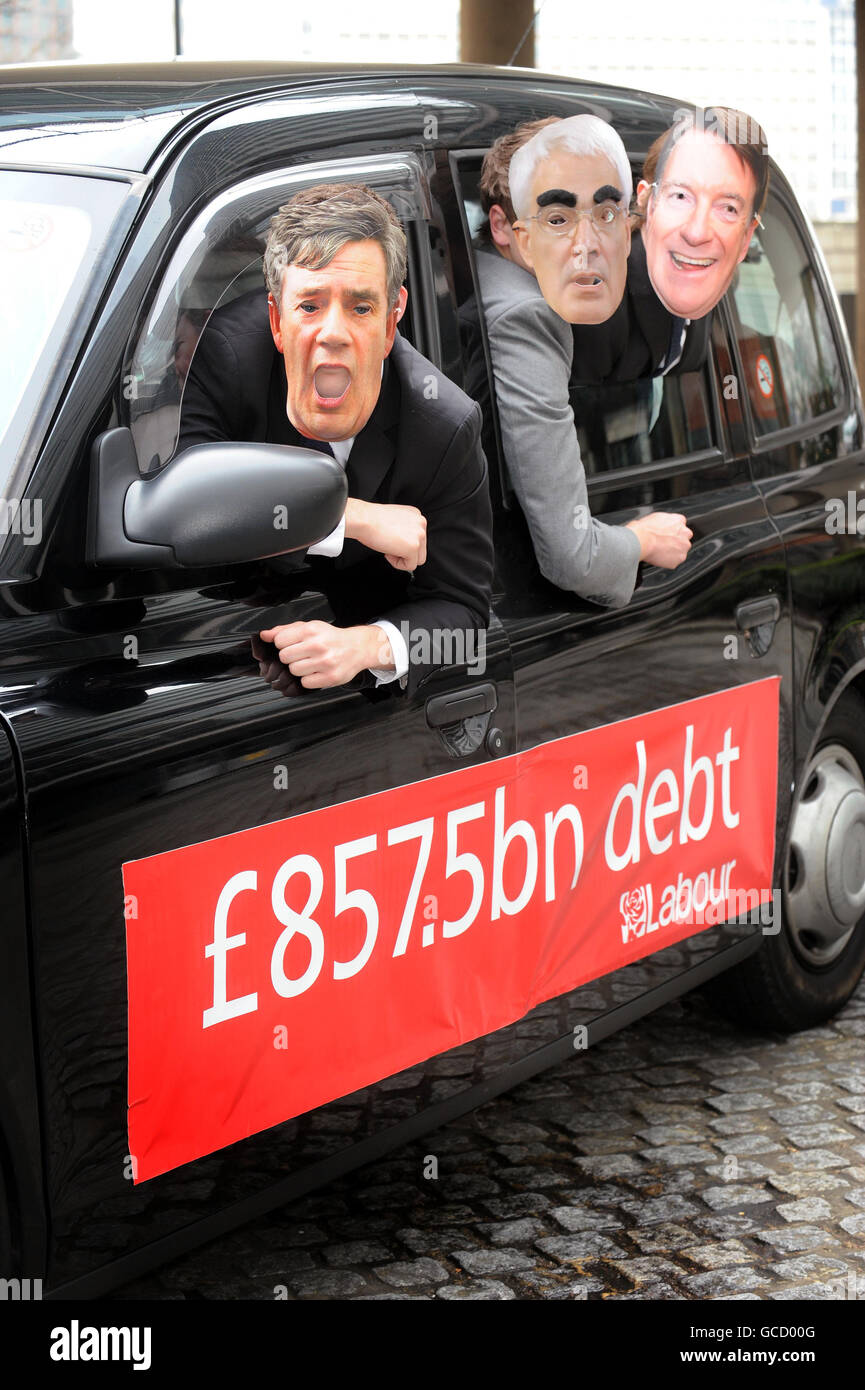 A line of masks featuring the faces of Prime Minister Gordon Brown and members of his Cabinet are held out of the windows of two black cabs during a Conservative party Budget Day stunt outside the party's HQ in Millbank, central London. Stock Photo