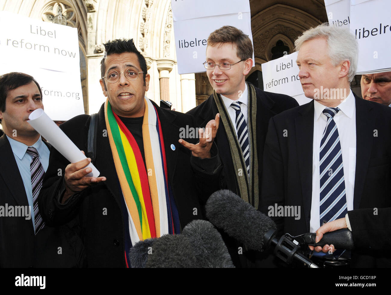 Science writer Simon Singh (second left) with supporters including David Davis MP (right), outside the High Court, London, after Mr Singh won his Court of Appeal battle for the right to rely on the defence of fair comment in a libel action. Stock Photo