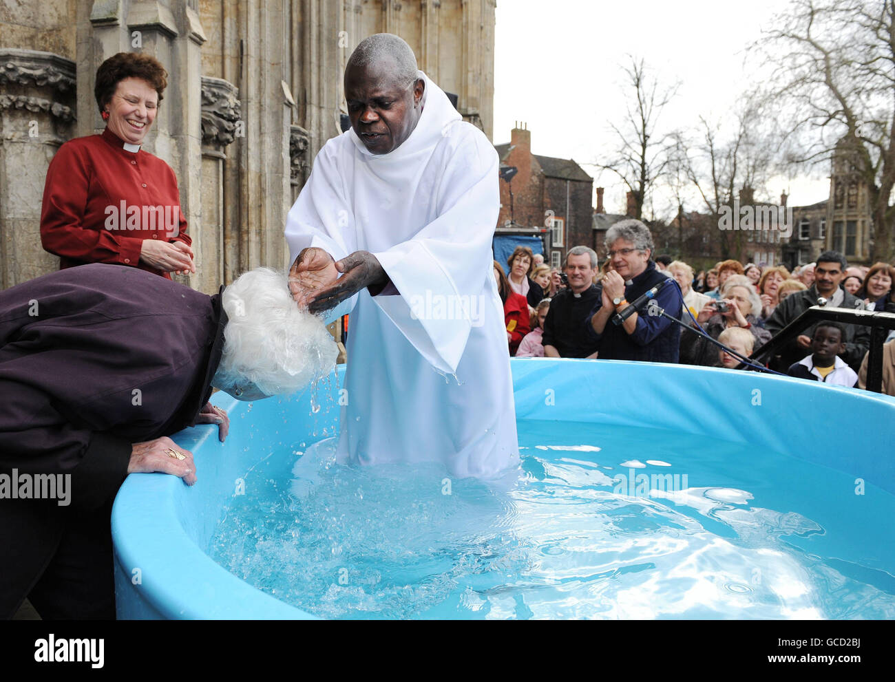 The Archbishop of York, Dr John Sentamu baptises June Cresswell, 84, during Easter baptisms outside York Minster, York. Stock Photo