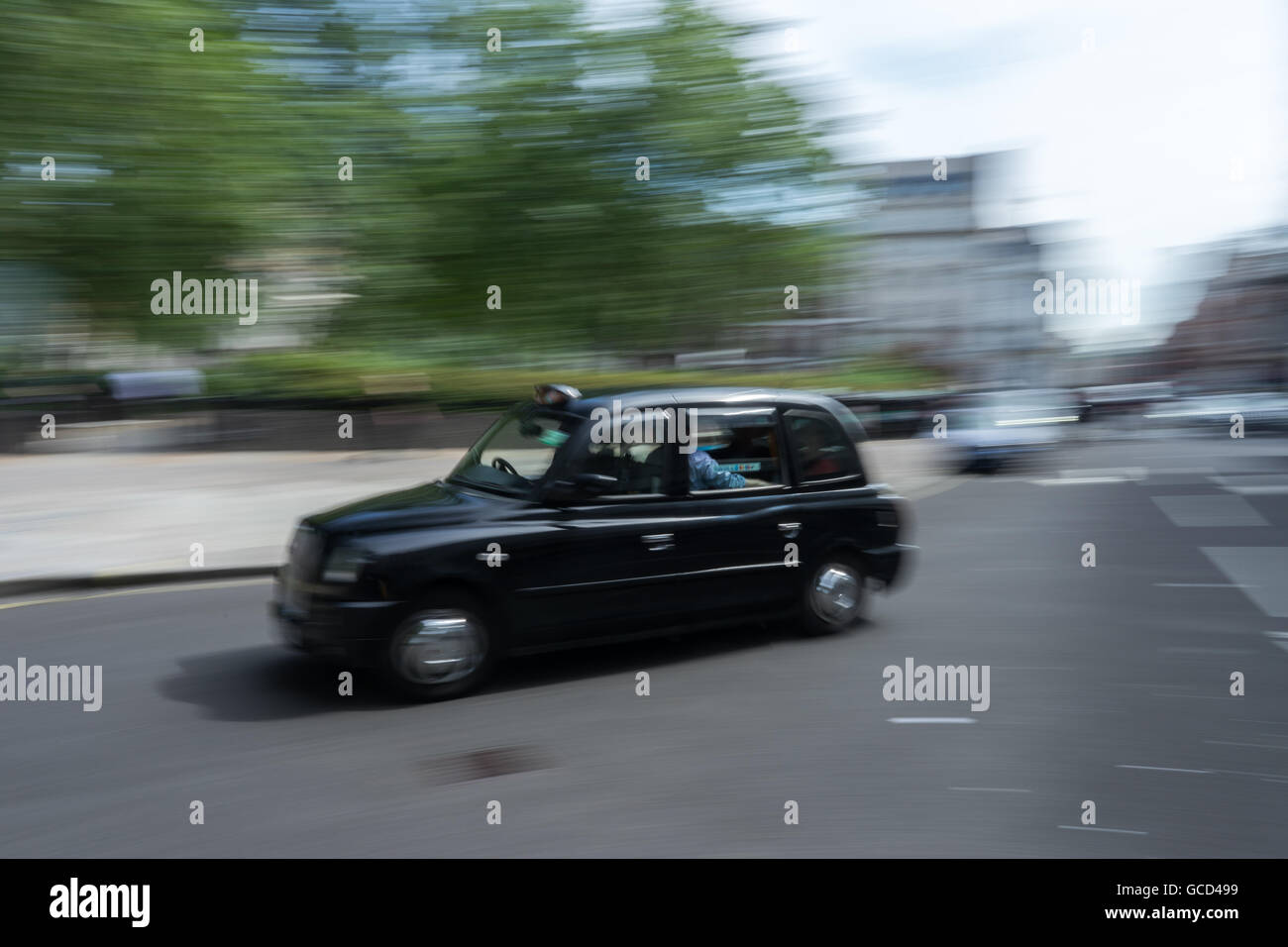 London Black Taxi Cab in motion in traffic Stock Photo