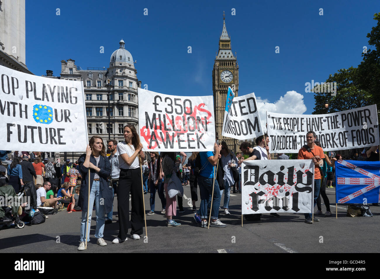 Anti- Brexit protestors wave banners against the UK Governments decision to leave European Union, crowds on street near parliament westminster. Stock Photo