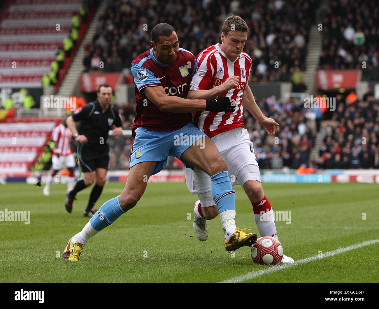 Aston Villa's John Carew (left) and Stoke City's Danny Collins (rigth) battle for the ball. Stock Photo